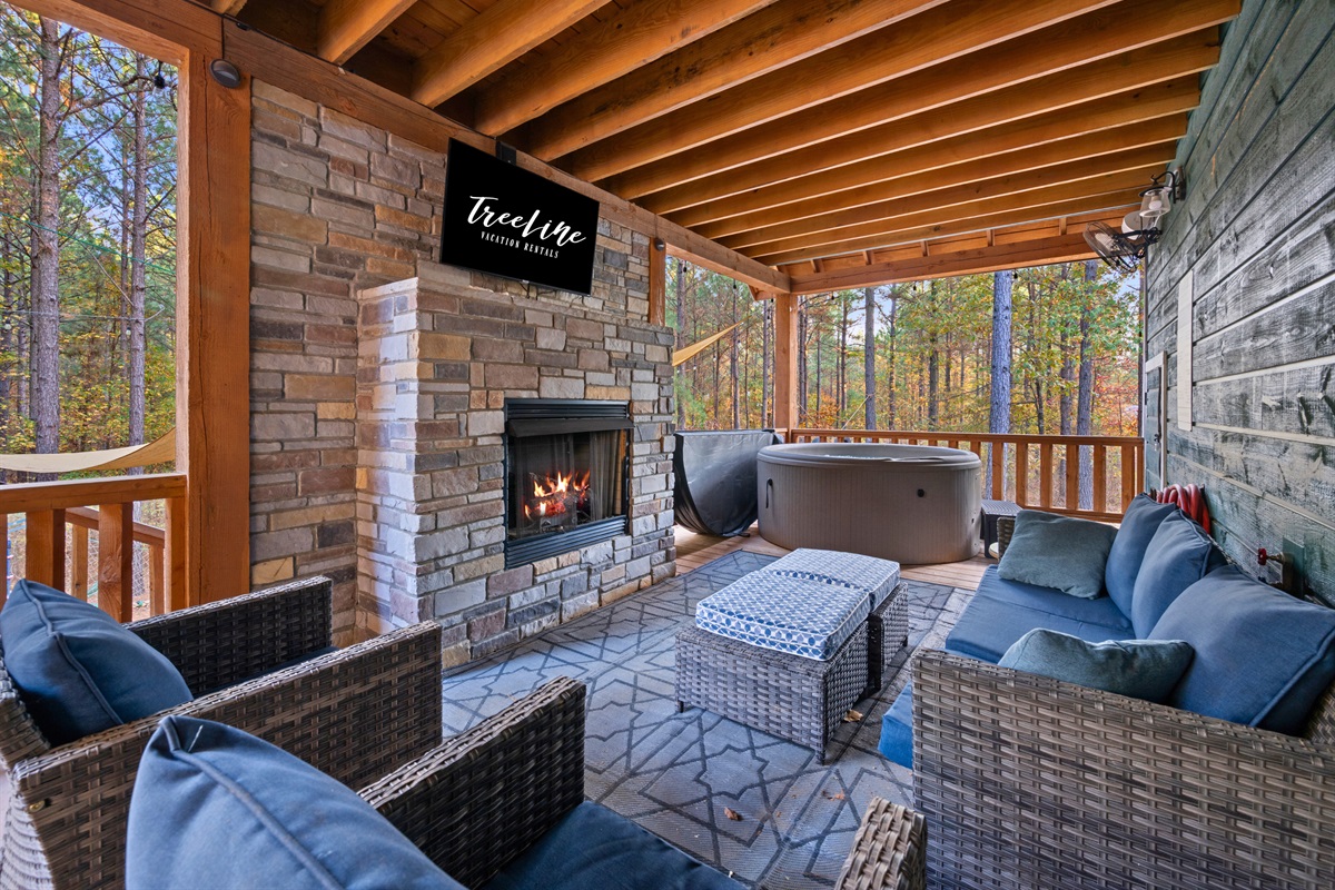 Enjoy the serene pine views from this comfortable outdoor seating area. Ideal for evening relaxation by the fire.