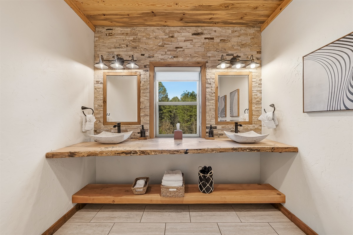 Modern rustic bathroom with live edge counters and dual sinks.