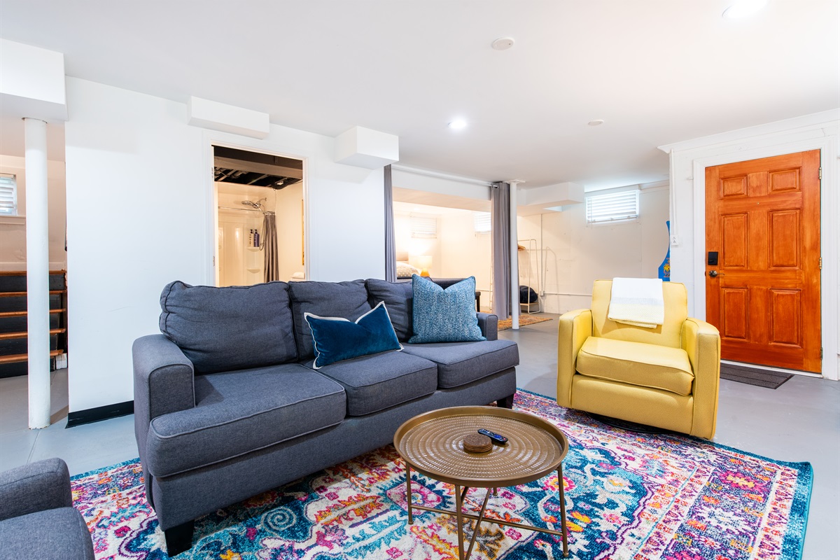 Basement lounge with full bath + laundry nearby 