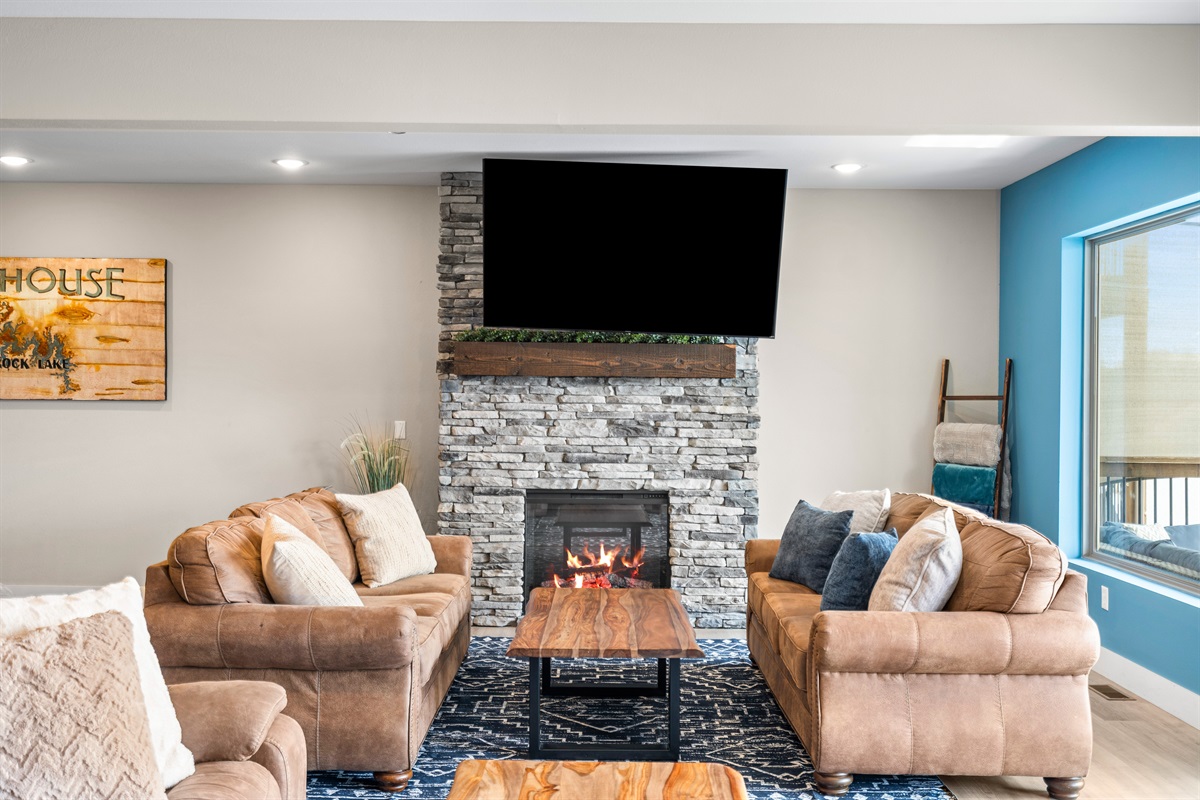 Cozy living room with a stone fireplace and stunning views—your perfect retreat for relaxation!