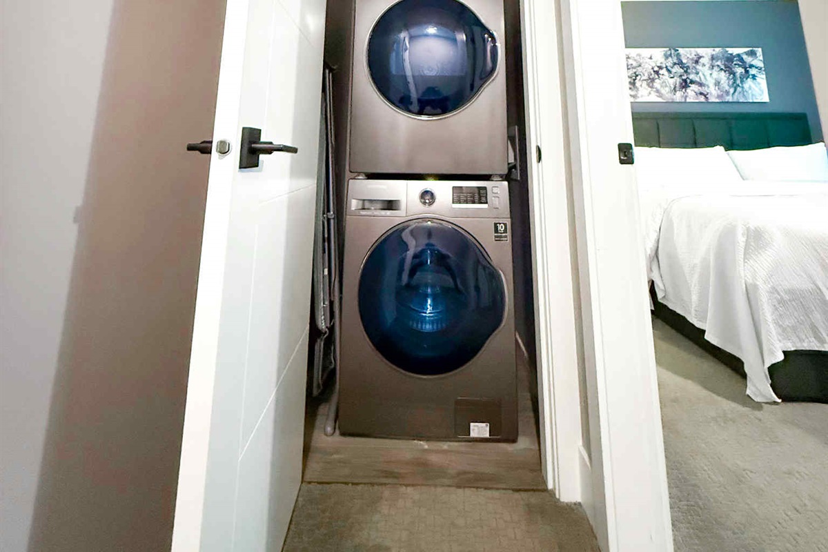 Stackable Washer and Dryer. Also, ironing board and vacuum kept in Laundry Area.