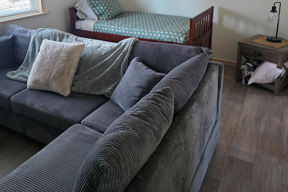 Loft area includes sectional sofa and additional bed (twin bed with trundle bed).