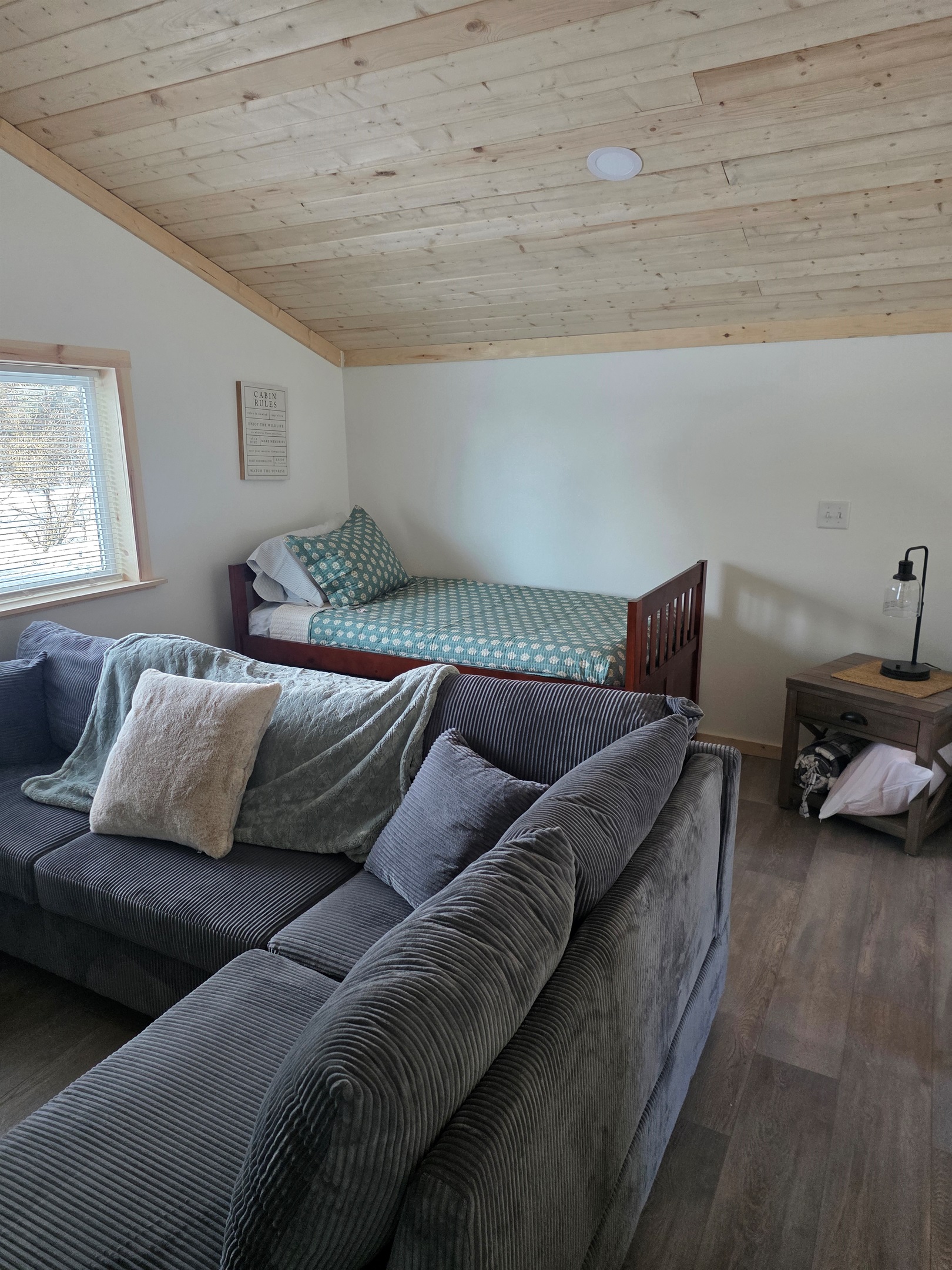 Loft area includes sectional sofa and additional bed (twin bed with trundle bed).