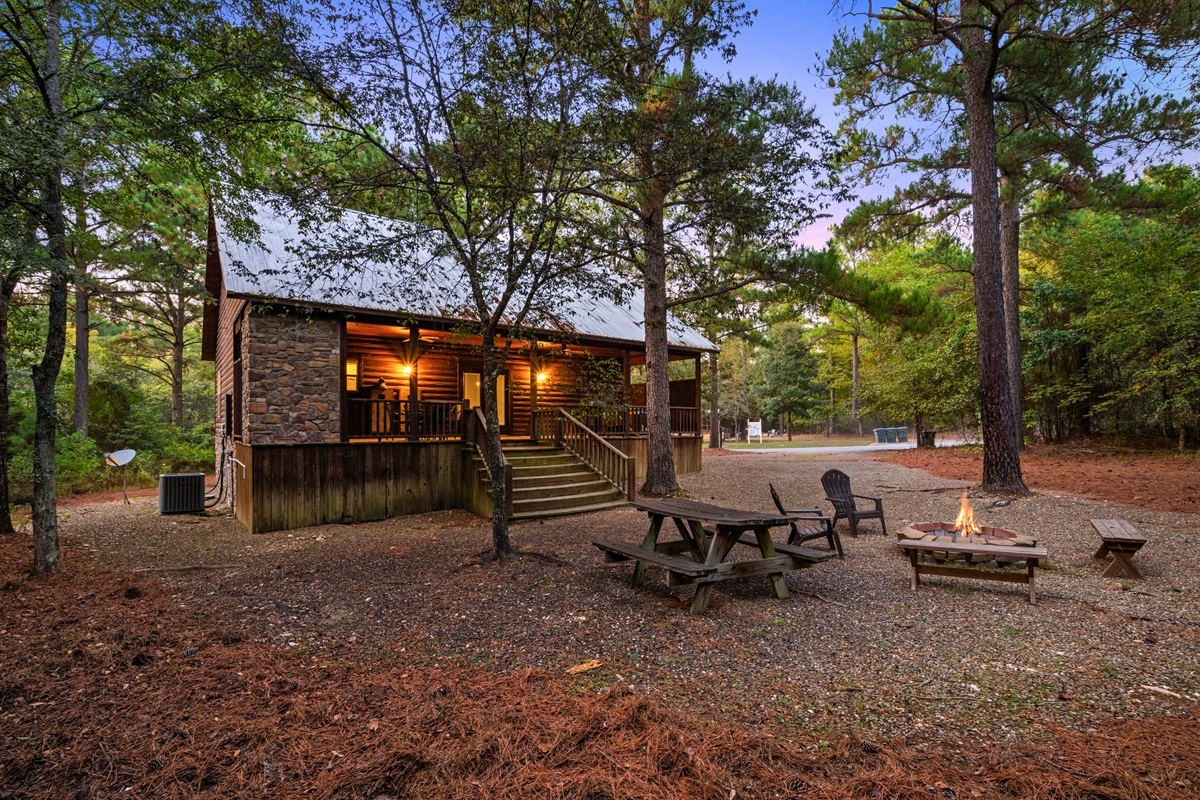 Spacious backyard with firepit, seating, and peaceful forest views.