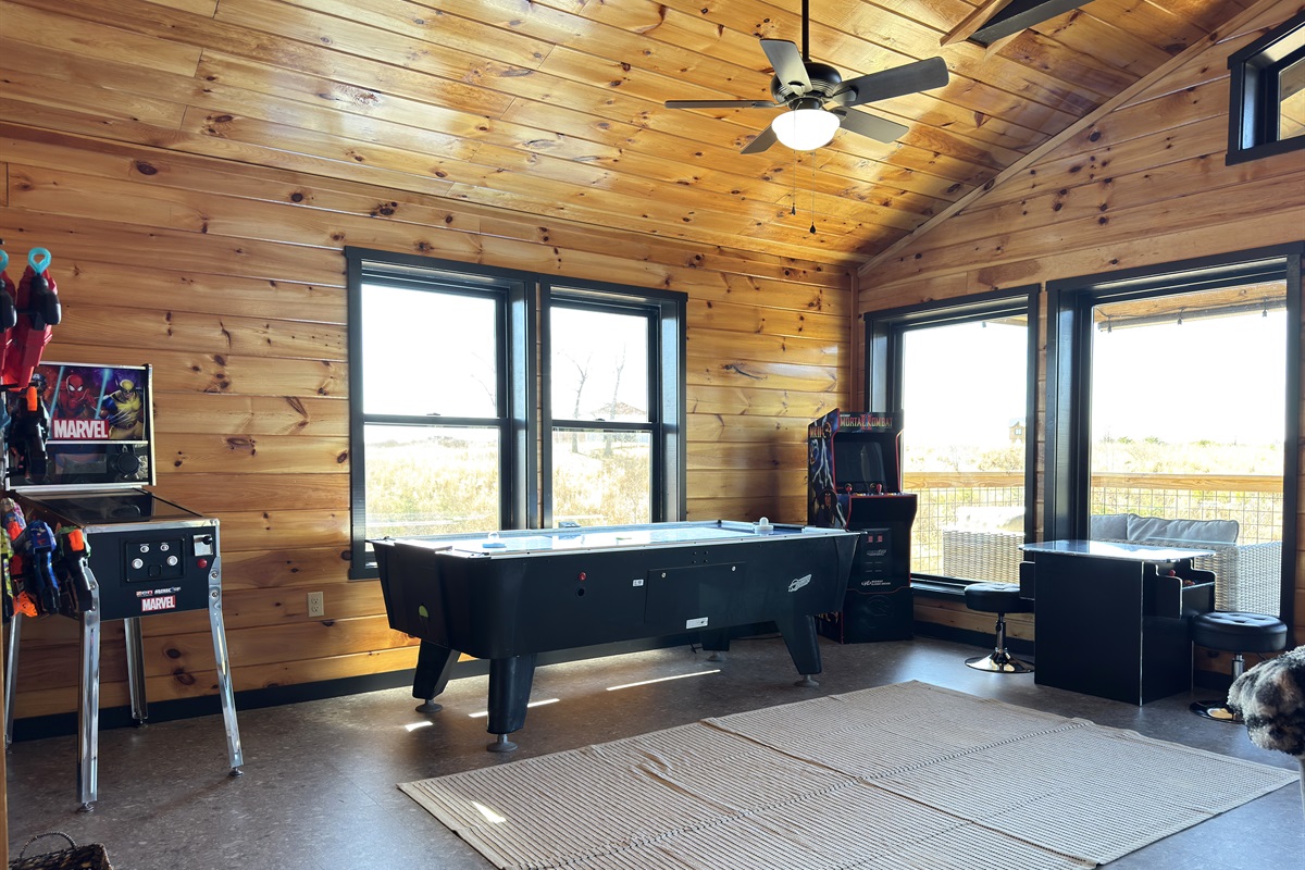 Upstairs game room with nerf blaster, air hockey, & retro arcades.