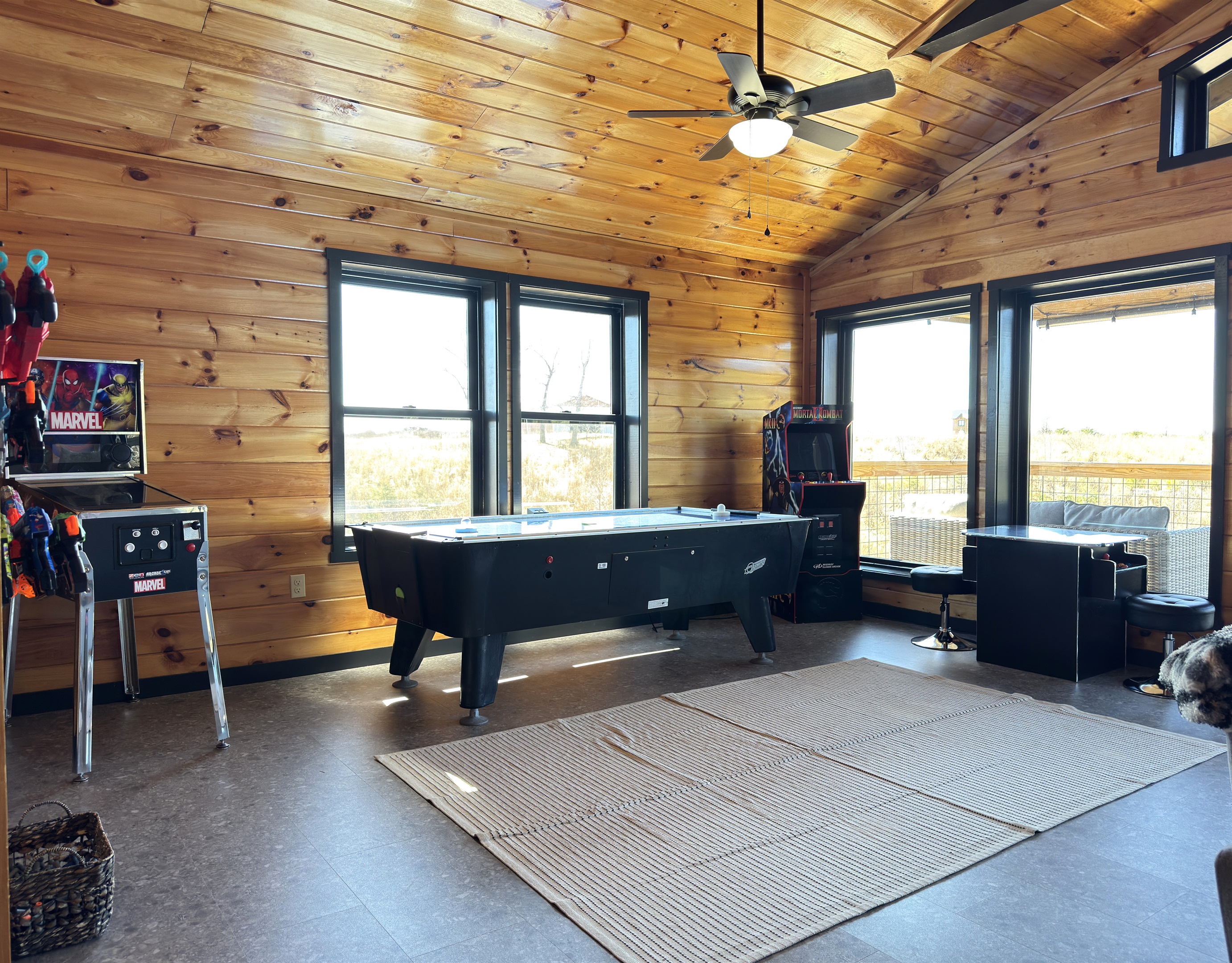 Upstairs game room with nerf blaster, air hockey, & retro arcades.
