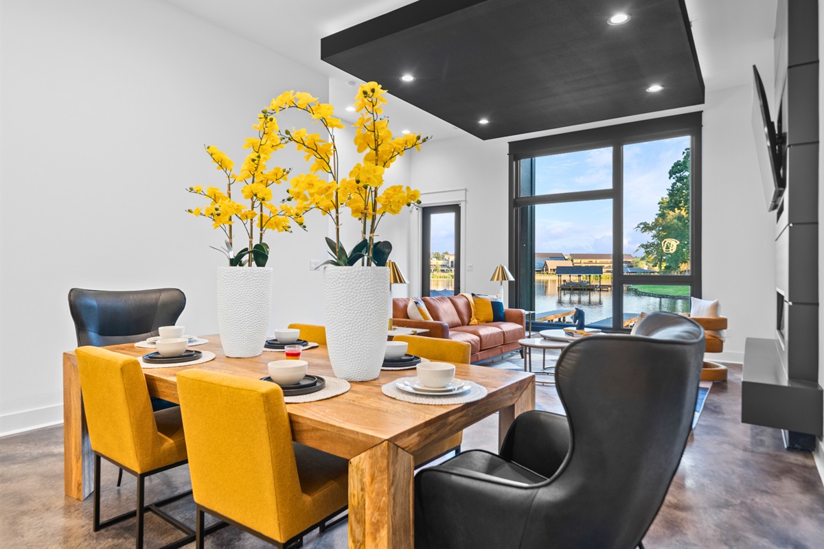 Gather in this modern dining space, where bold yellow accents and artistic details make every meal a vibrant experience.