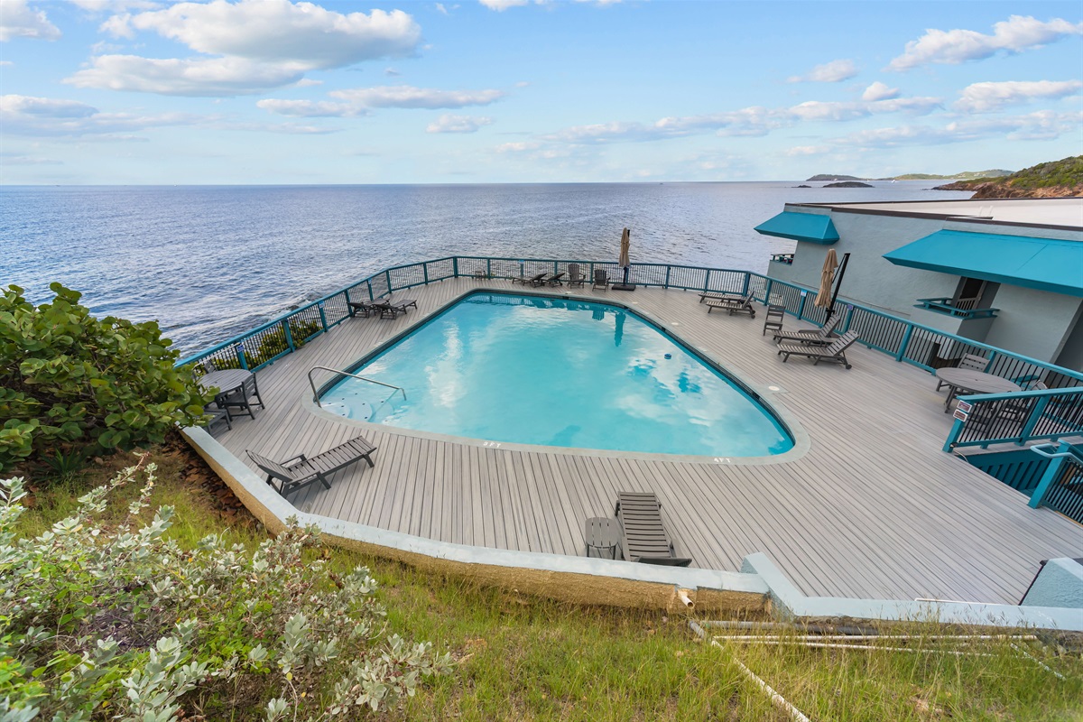 The cliffside pool is steps from your balcony