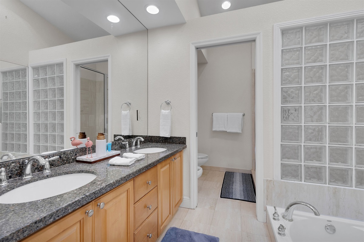 Large Master Bedroom Suite, with jacuzzi tub and walk-in shower, and two walk-in closets.