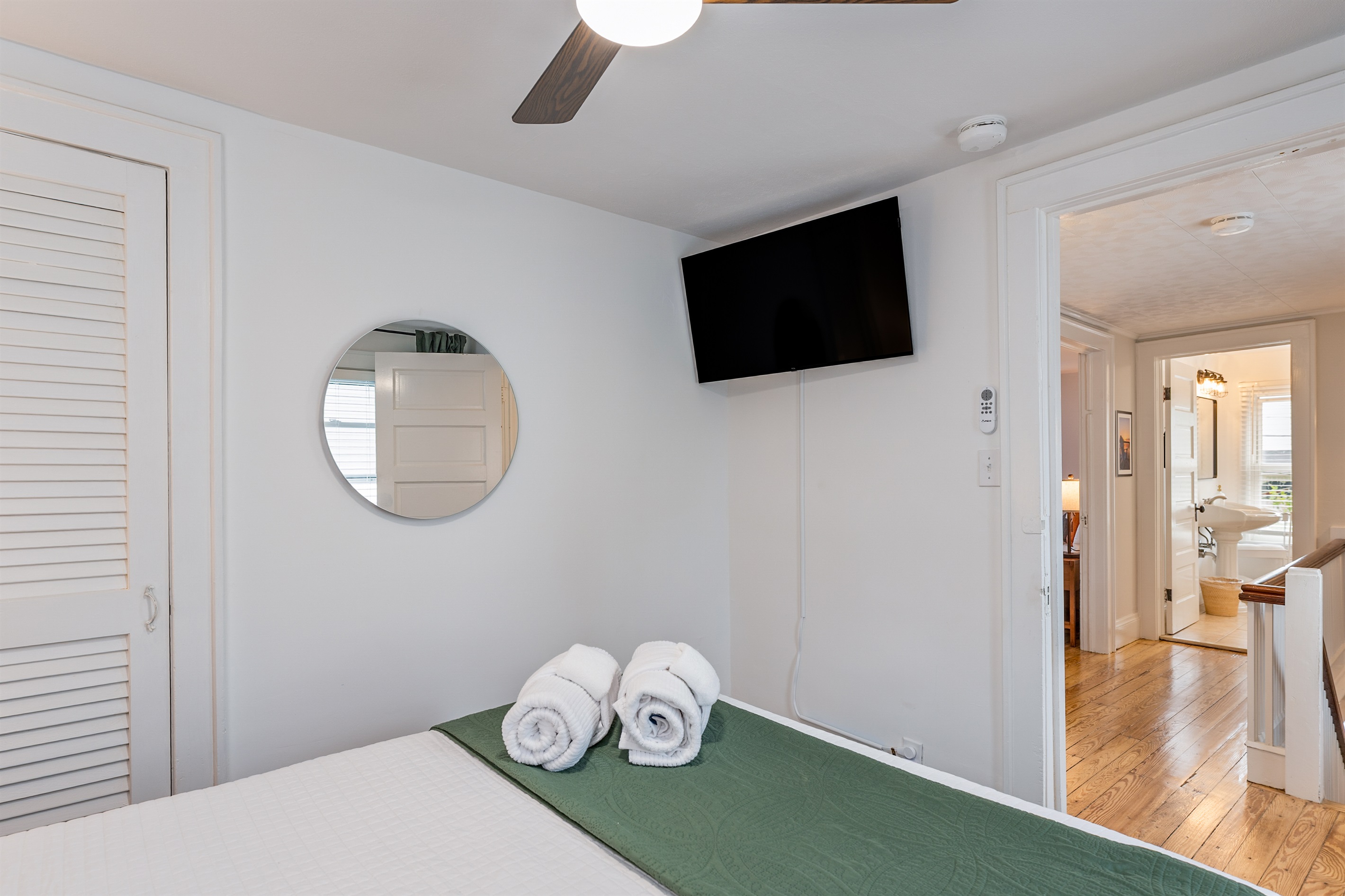 Unwind in this cozy bedroom with a ceiling fan, mounted TV, and queen bed—perfect for a peaceful night after exploring the Finger Lakes. Bedroom #3