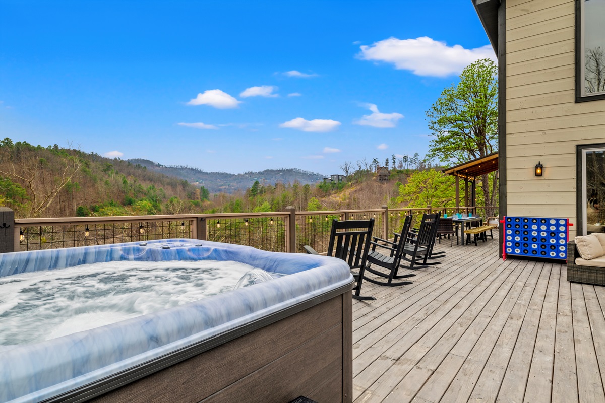 Soak in the hot tub while taking in panoramic Smoky Mountain views, then relax in the rocking chairs or challenge your group to a game of giant Connect Four on the spacious deck.