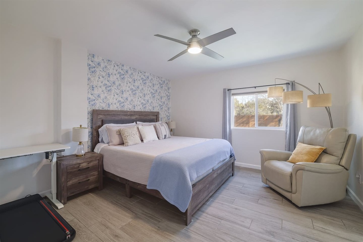 Retreat to this spacious downstairs king suite, where soft textures, calming tones, and a cozy reading corner create the perfect place to unwind. Designed for restful mornings and deep, comfortable sleep.