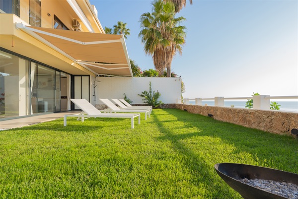 Wake up to a picture-perfect morning at Casa Folimanka! The garden invites you to relax on sun loungers, surrounded by lush green grass, under the clear blue sky, with the sparkling blue sea as your backdrop. A serene start to your day in Torremolinos.