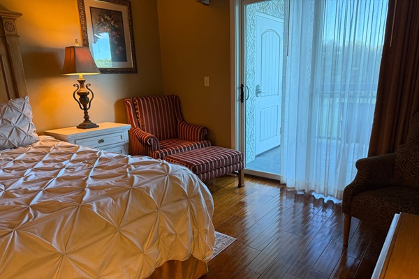 Enjoy your favorite book here in the primary bedroom while taking in the scenery from outside the balcony.
