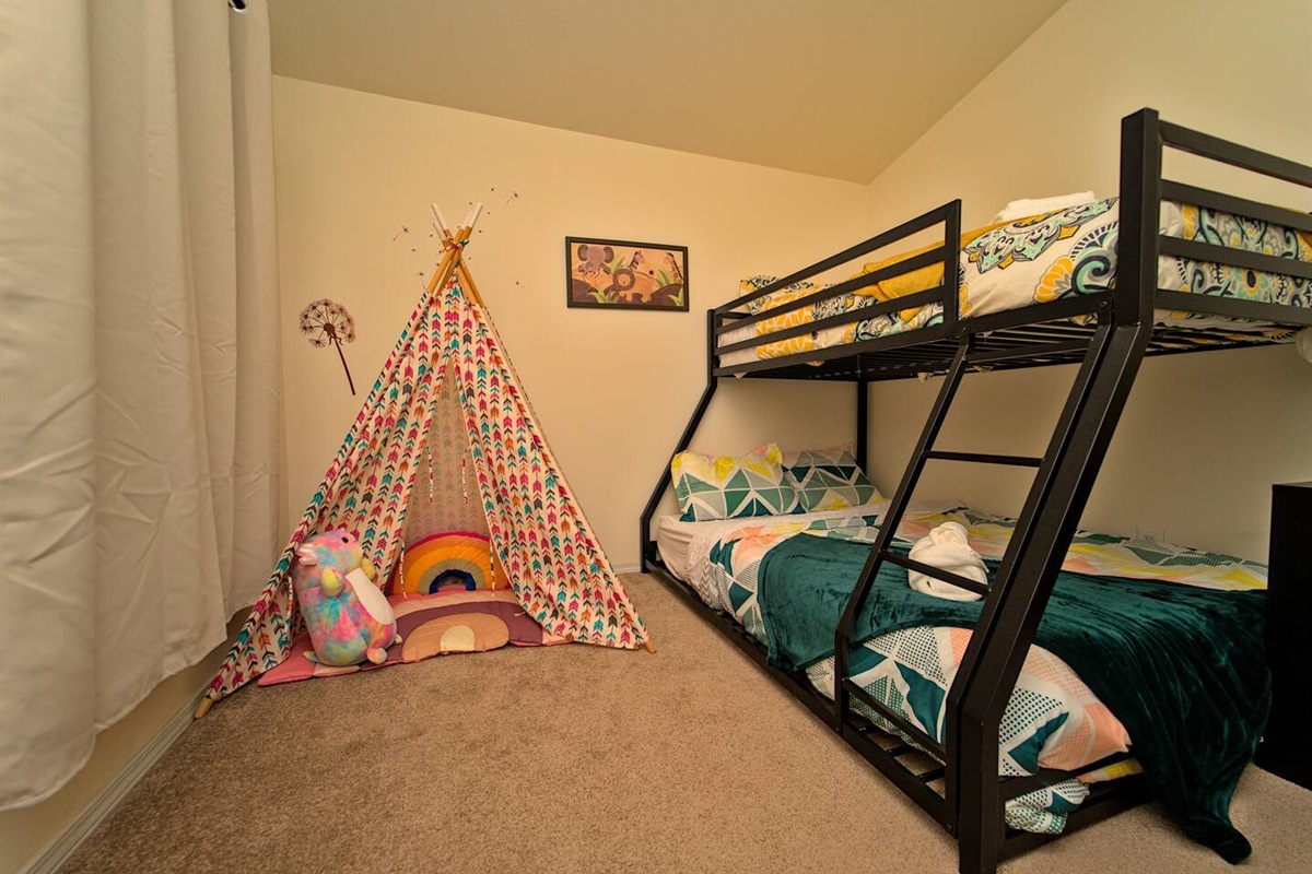 Third bedroom featuring a bunk bed and play tent.