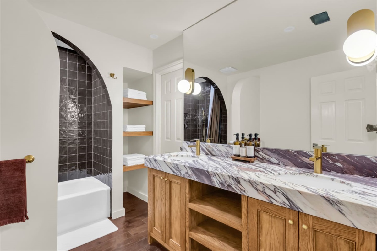 Bathroom with a double vanity sink, providing ample space for shared use and added convenience during your stay.