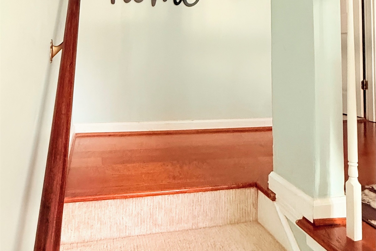Warm wood stairs and soft walls connect upper and lower levels with ease and style. 