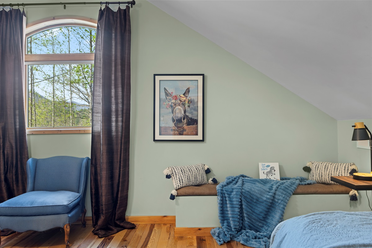 Queen Bedroom 3: Bright room with scenic views, comfy seating, and whimsical decor awaits!