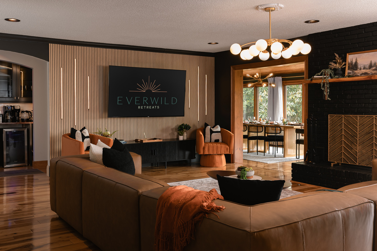 {Living Room} An open-concept gathering space connects the living room and kitchen so the whole group can relax, cook, and spend time together.