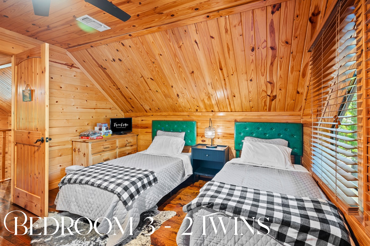 Bedroom 3 includes two twin beds with soft bedding and playful touches, ideal for kids or extra guests.