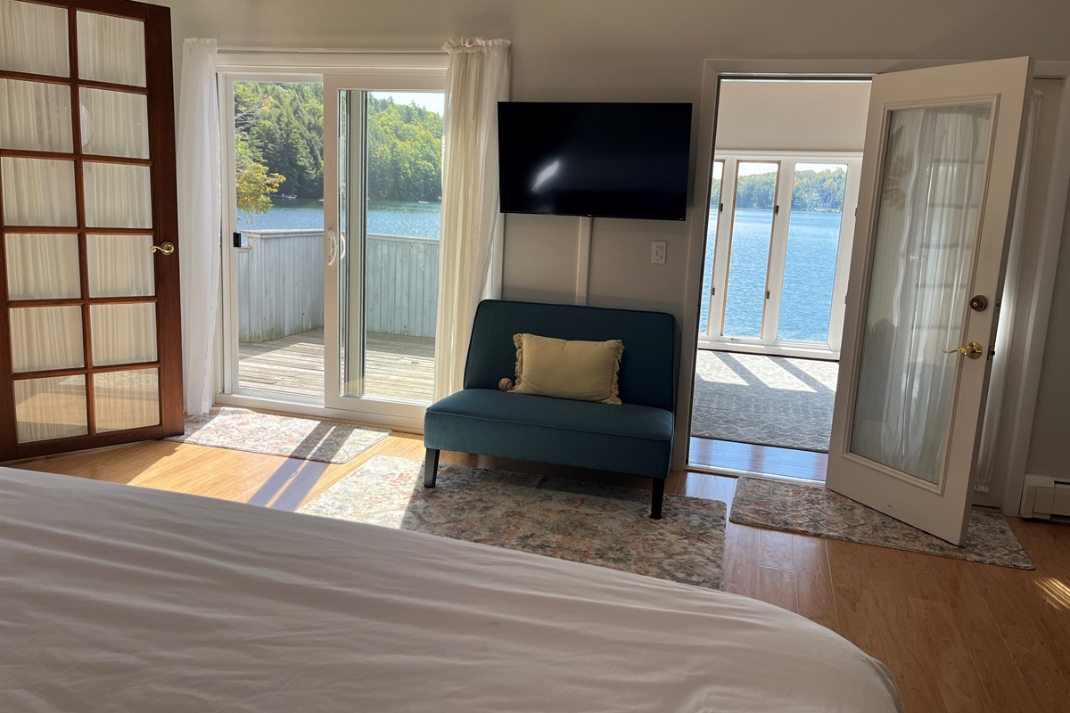West wing - 2nd floor King bedroom w/ private balcony and sunroom overlooking the lake.