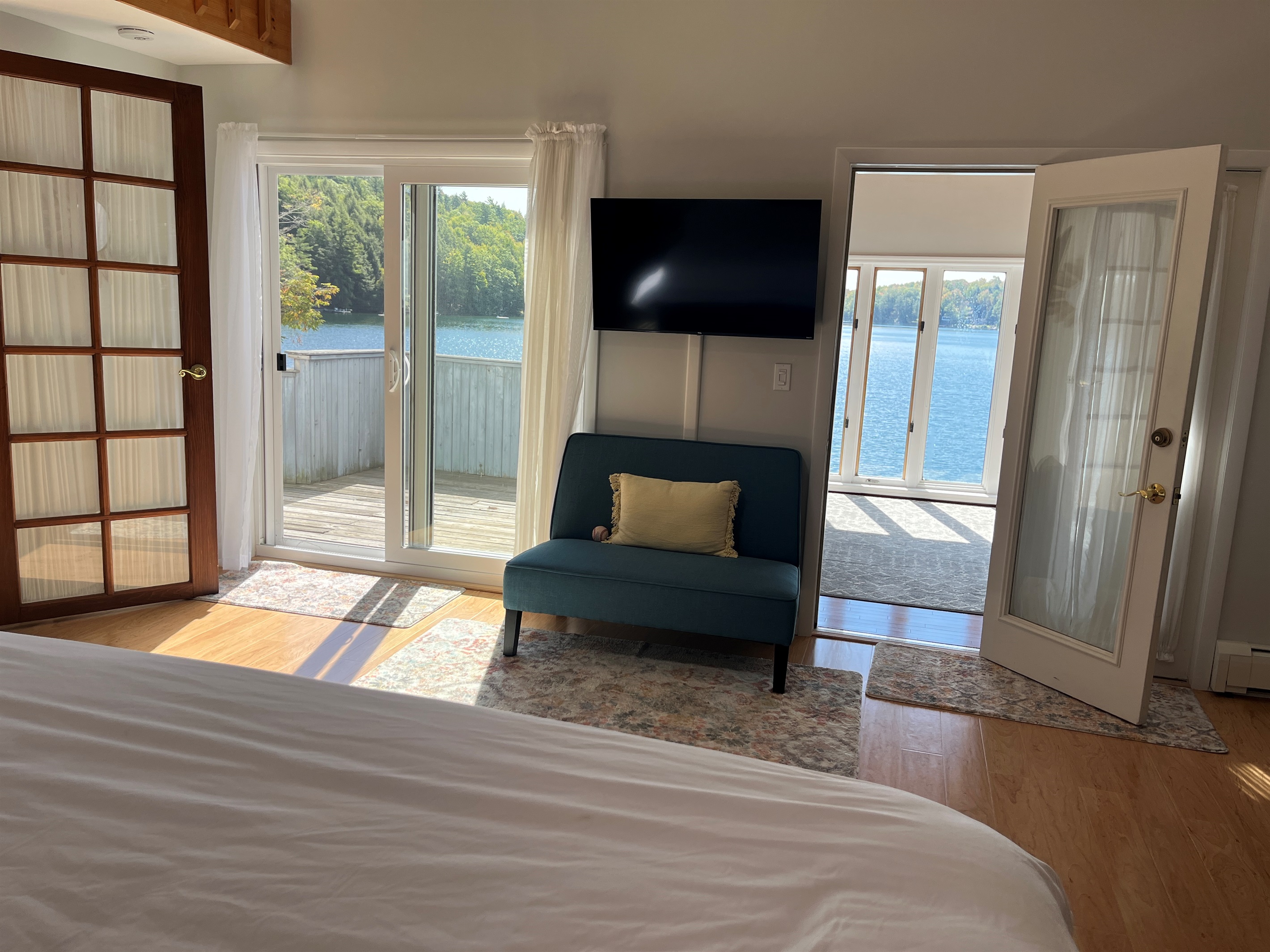 West wing - 2nd floor King bedroom w/ private balcony and sunroom overlooking the lake.