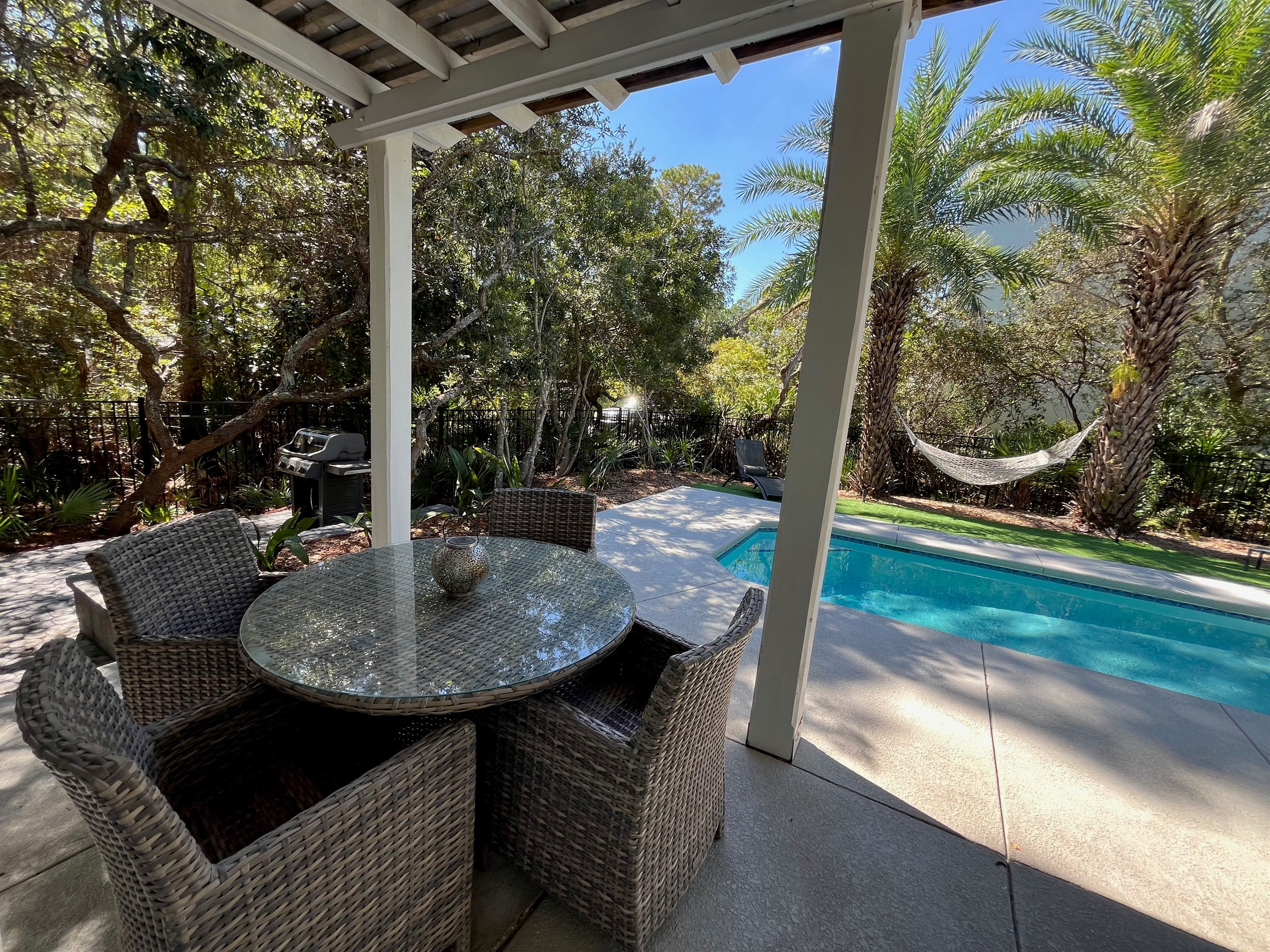 Private backyard complete with covered poolside dining