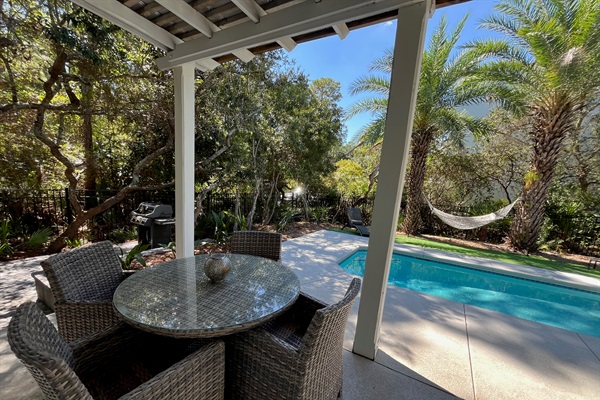 Private backyard complete with covered poolside dining