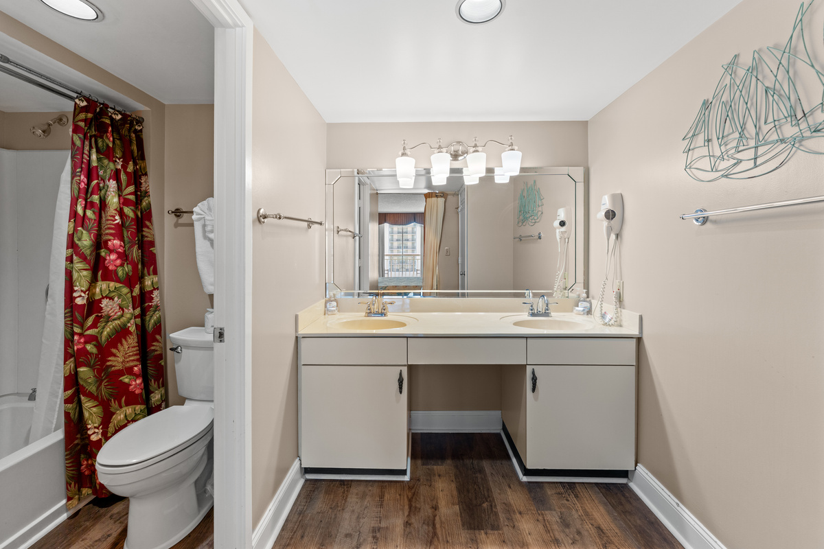 Main Bathroom with double sinks and tub/shower combo