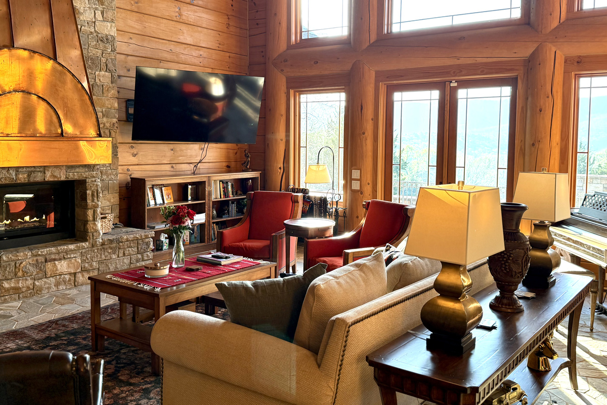 Bright living room with a large propane fireplace and stunning views throughout