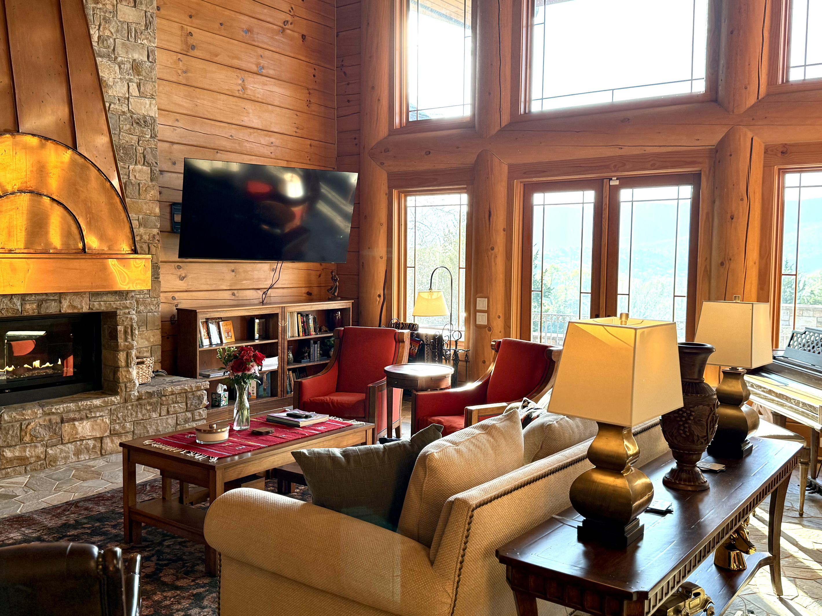 Bright living room with a large propane fireplace and stunning views throughout