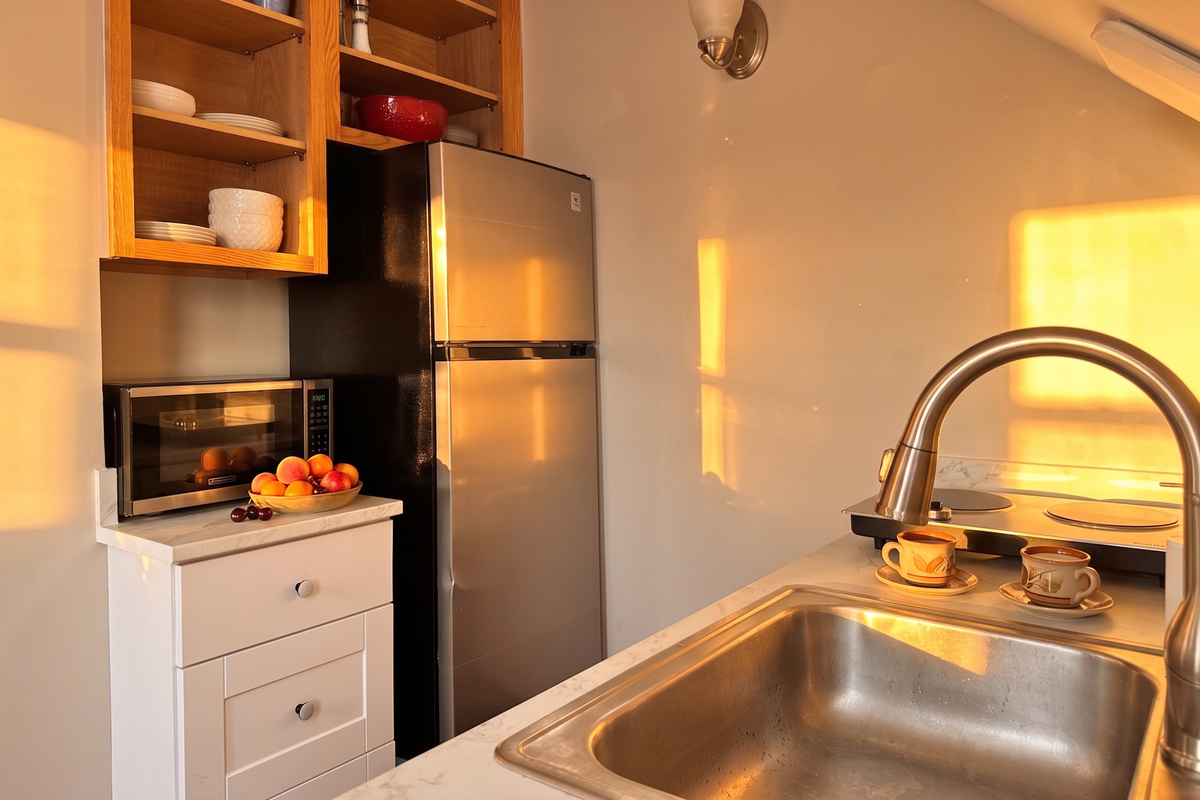 Mid size refrigerator with freezer and microwave provided in this well designed kitchen.