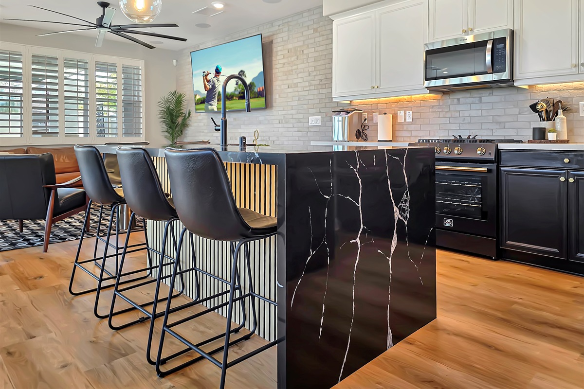 The kitchen's island has a custom waterfalled quartz counter.