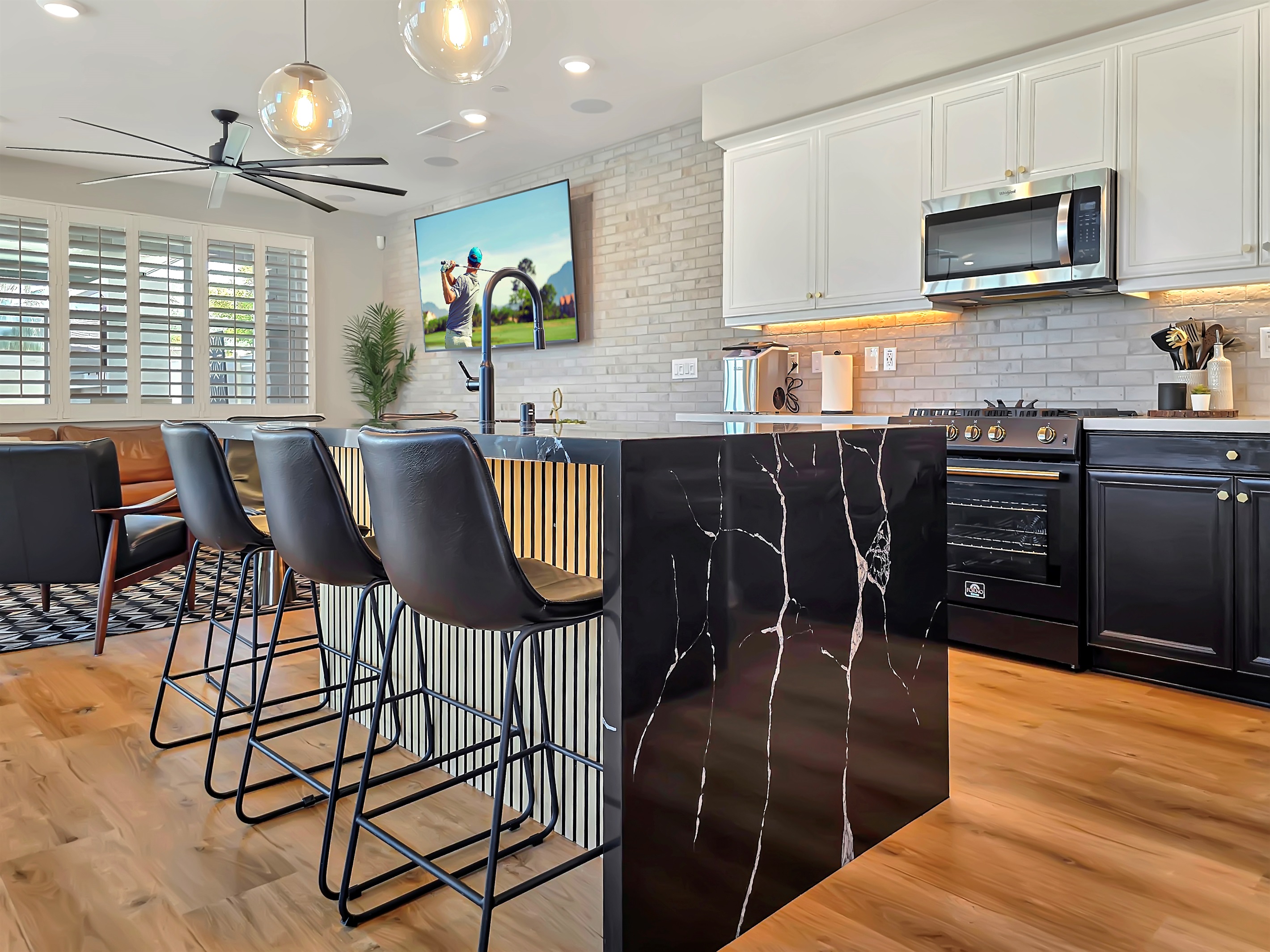 The kitchen's island has a custom waterfalled quartz counter.