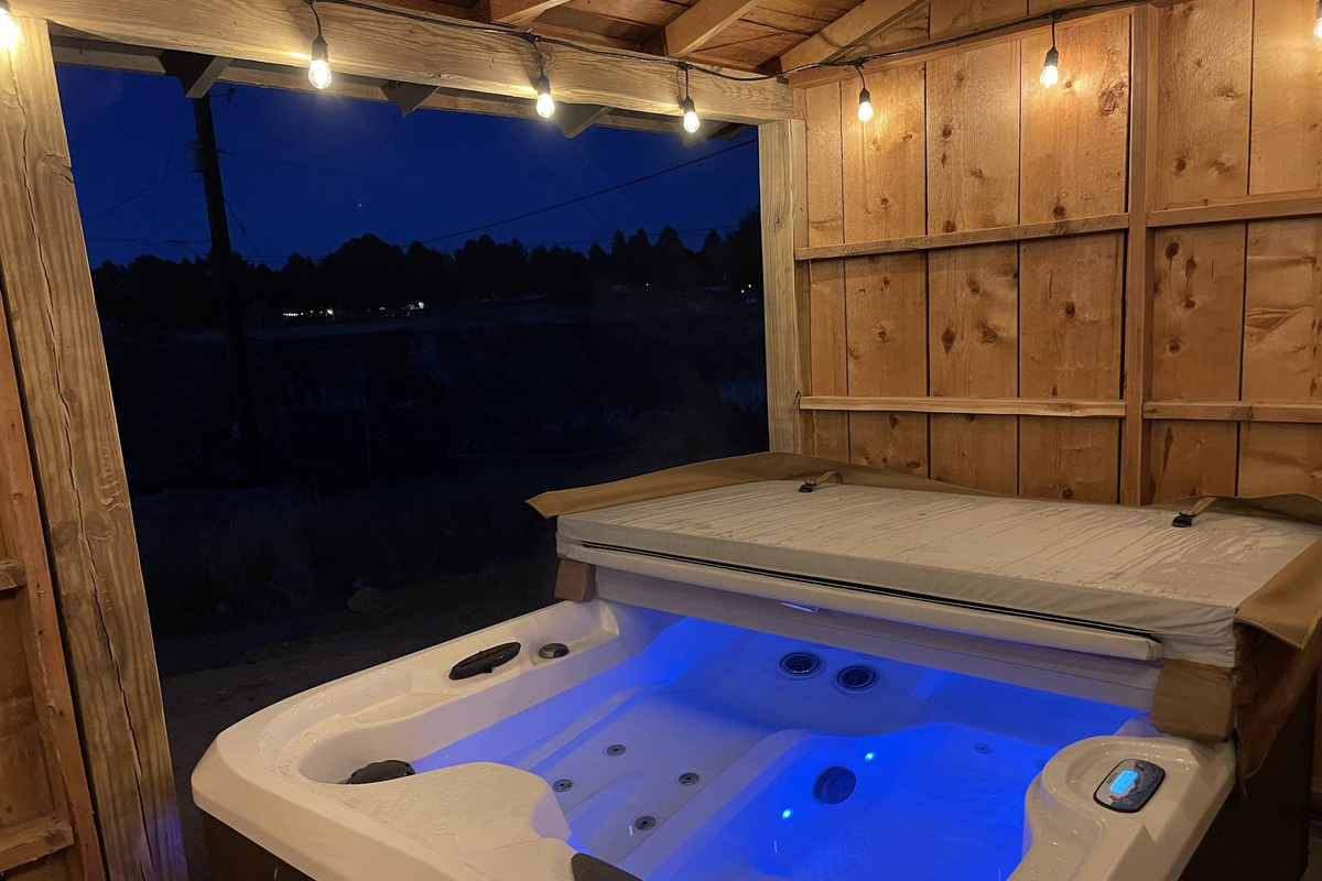 Soak beneath the canyon stars — the hot tub glows at night