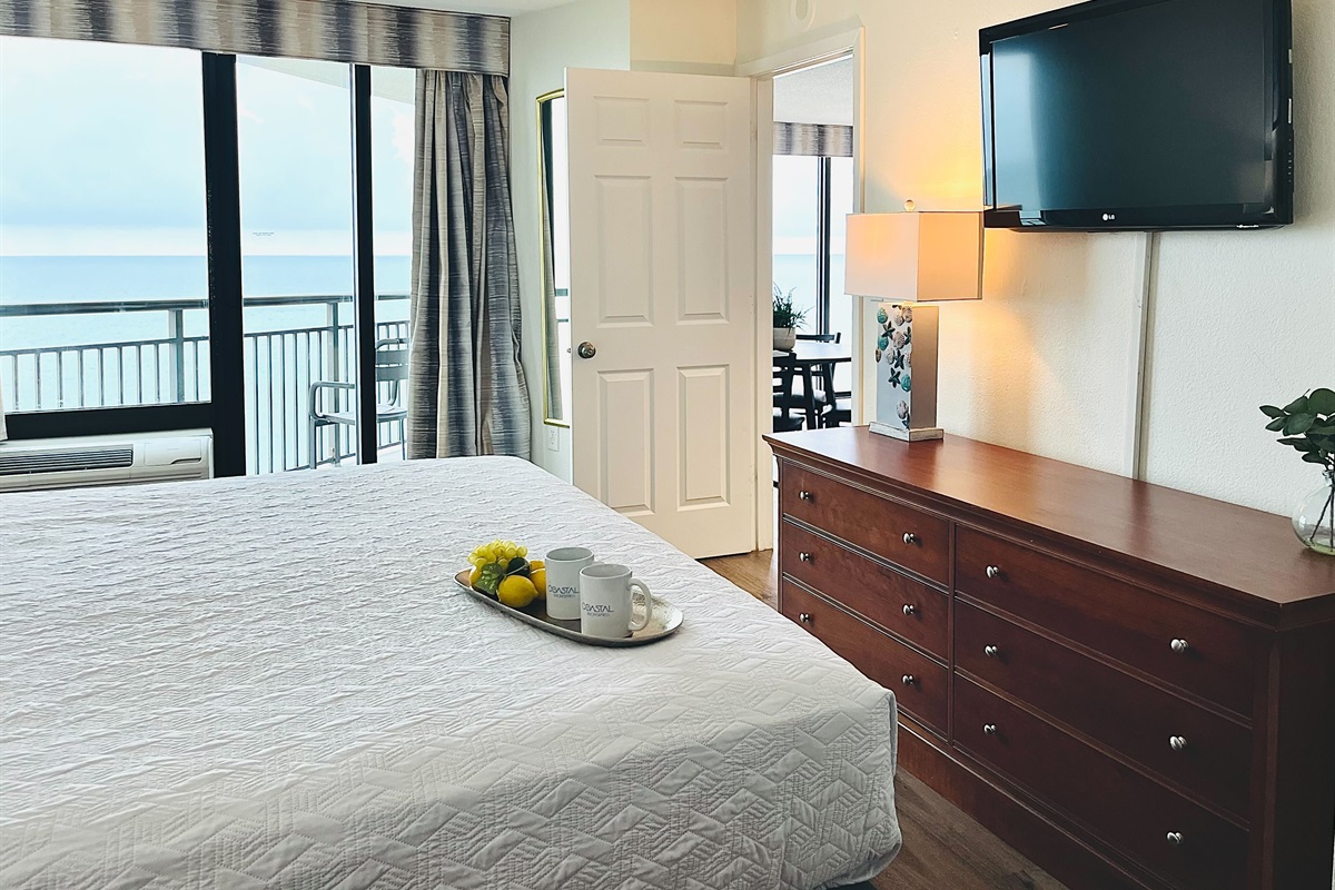 Drift into tranquility on a bed near the balcony of our oceanfront suite, where the gentle ocean breeze and stunning vistas create a peaceful haven.