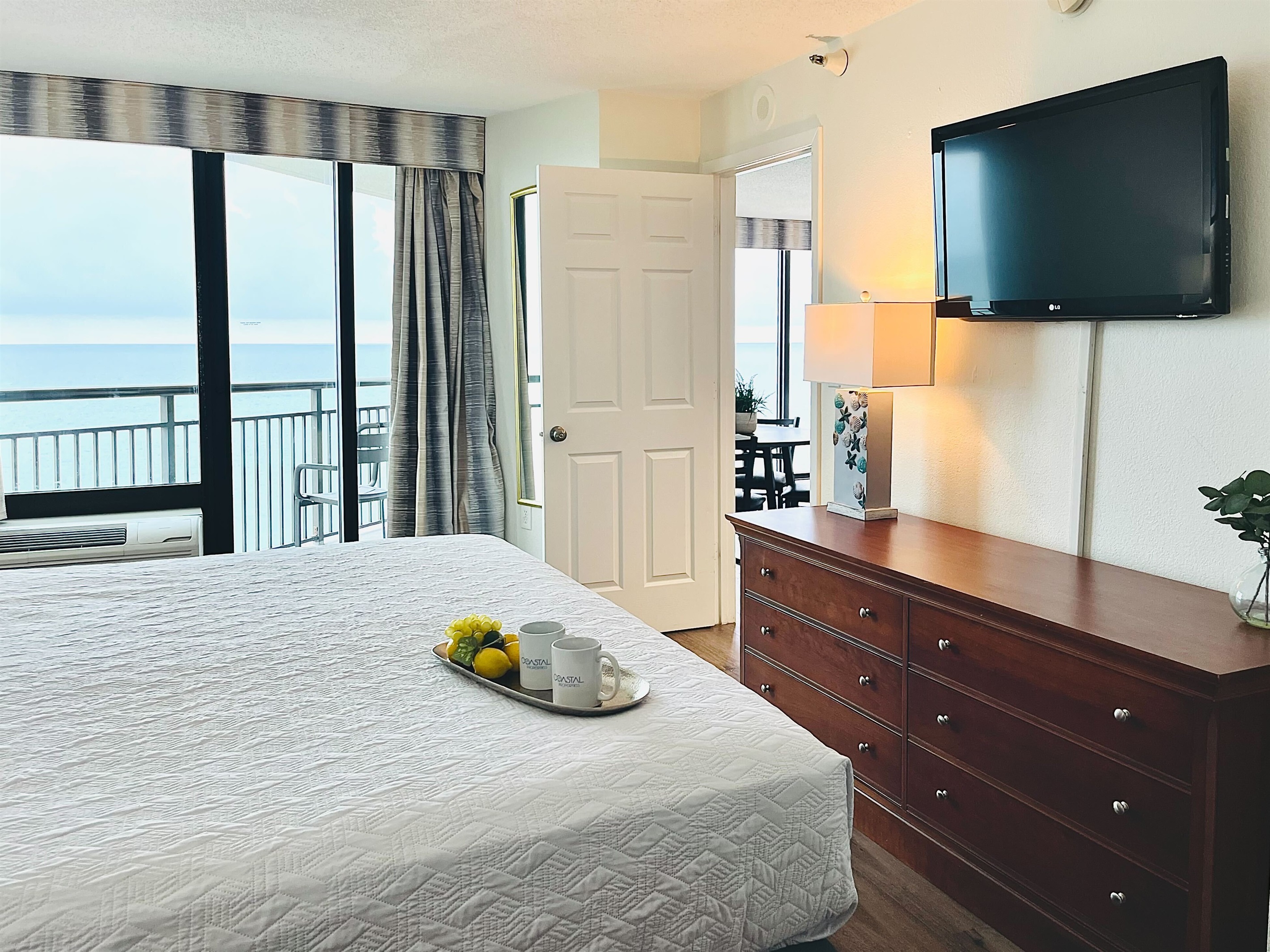Drift into tranquility on a bed near the balcony of our oceanfront suite, where the gentle ocean breeze and stunning vistas create a peaceful haven.
