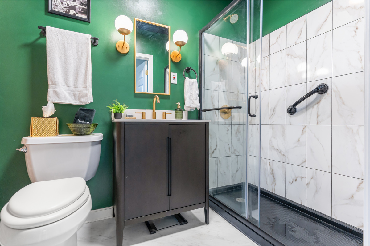 Fresh, modern and beautifully moody - this main floor full bath is the perfect place to start your morning.