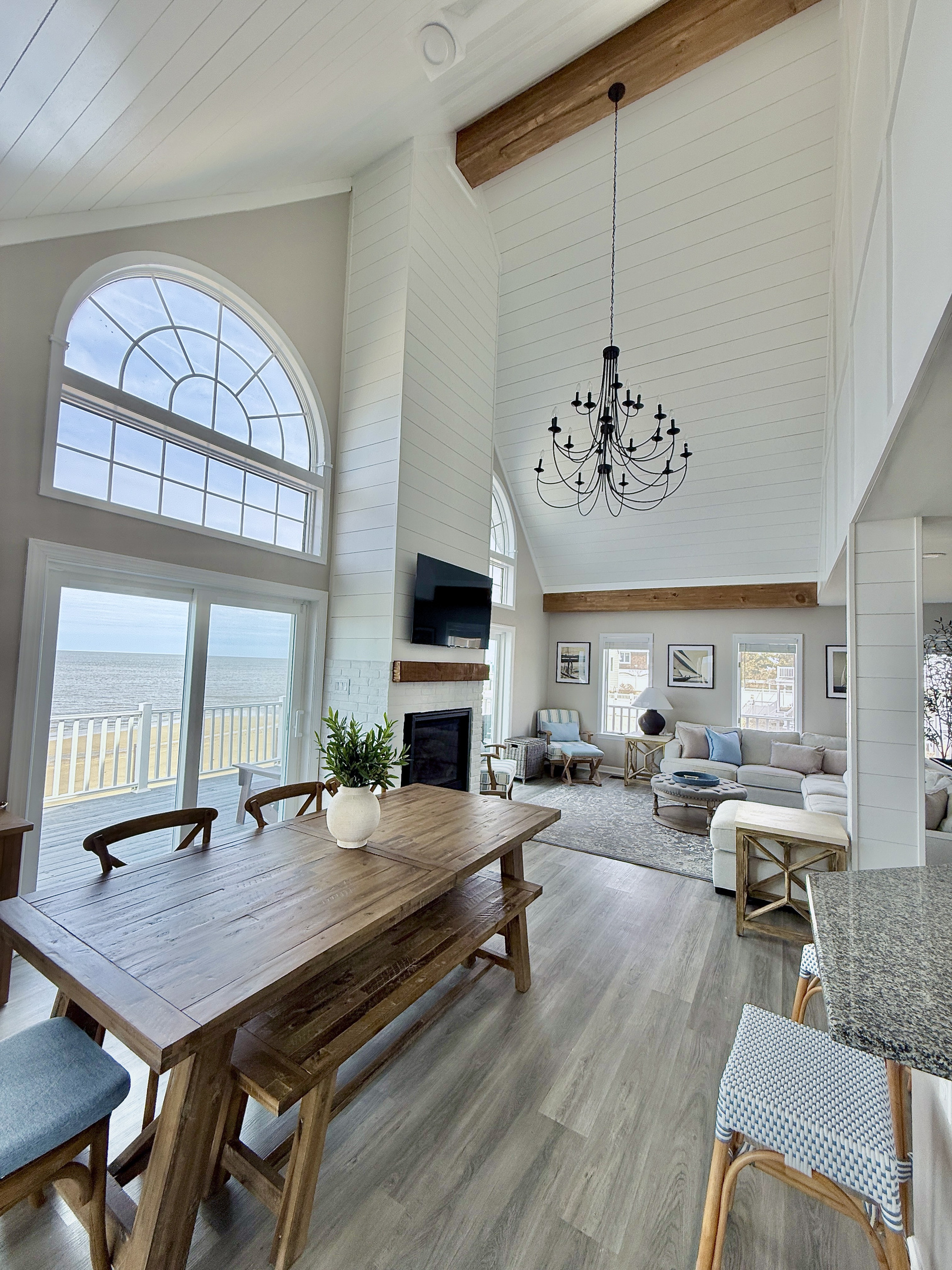 Experience effortless coastal living in our bright, open-concept living and dining area. Featuring warm wood accents, comfortable seating, and sliding glass doors that open directly to your private deck with stunning water views.