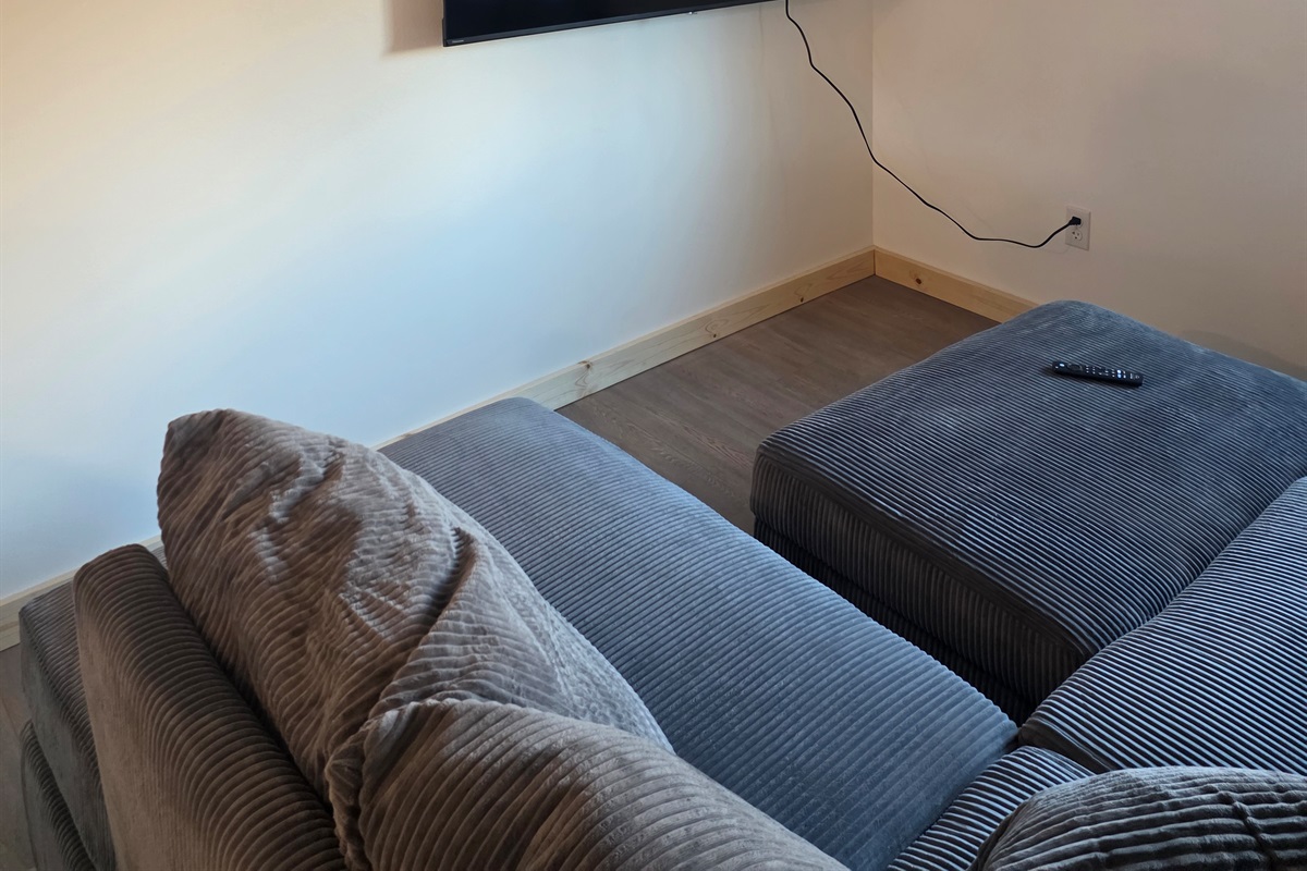 Loft living area - sectional sofa and big screen TV