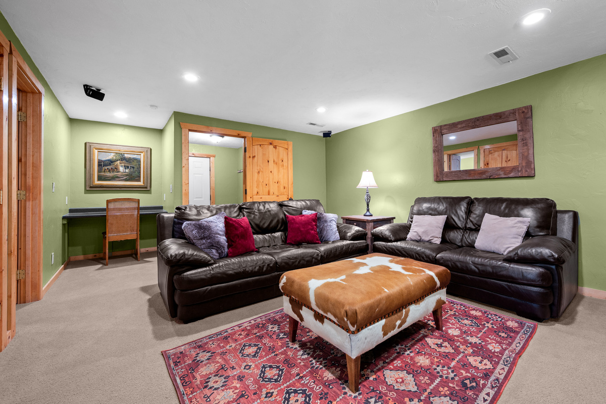 Spacious downstairs theater room with leather seating and room for the whole group.