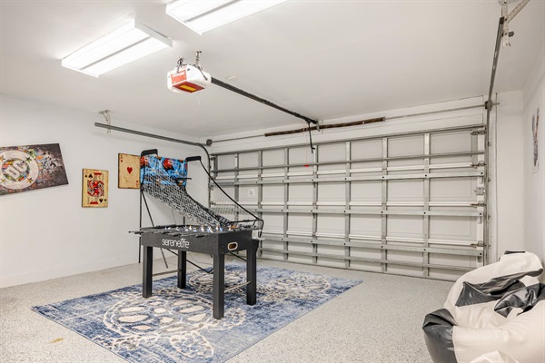 Game room area with foosball, bean bag chairs, and electronic basketball hoops.