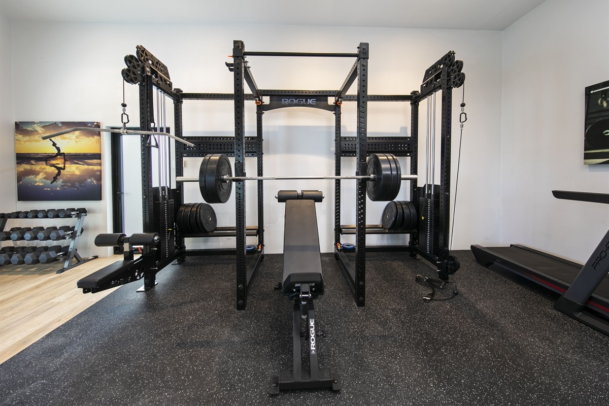 Gym is equipped with squat rack, bench press & more