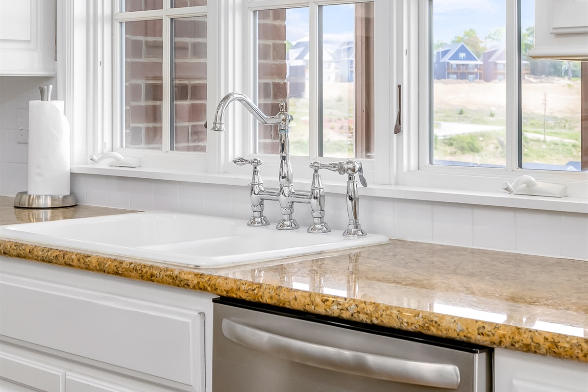 Kitchen window overlooks screened porch