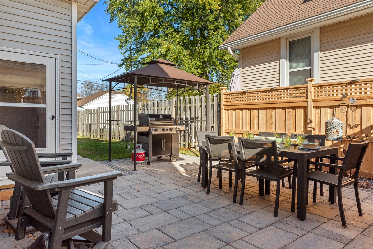 Gas grill and large outdoor dining table make dining alfresco a breeze.