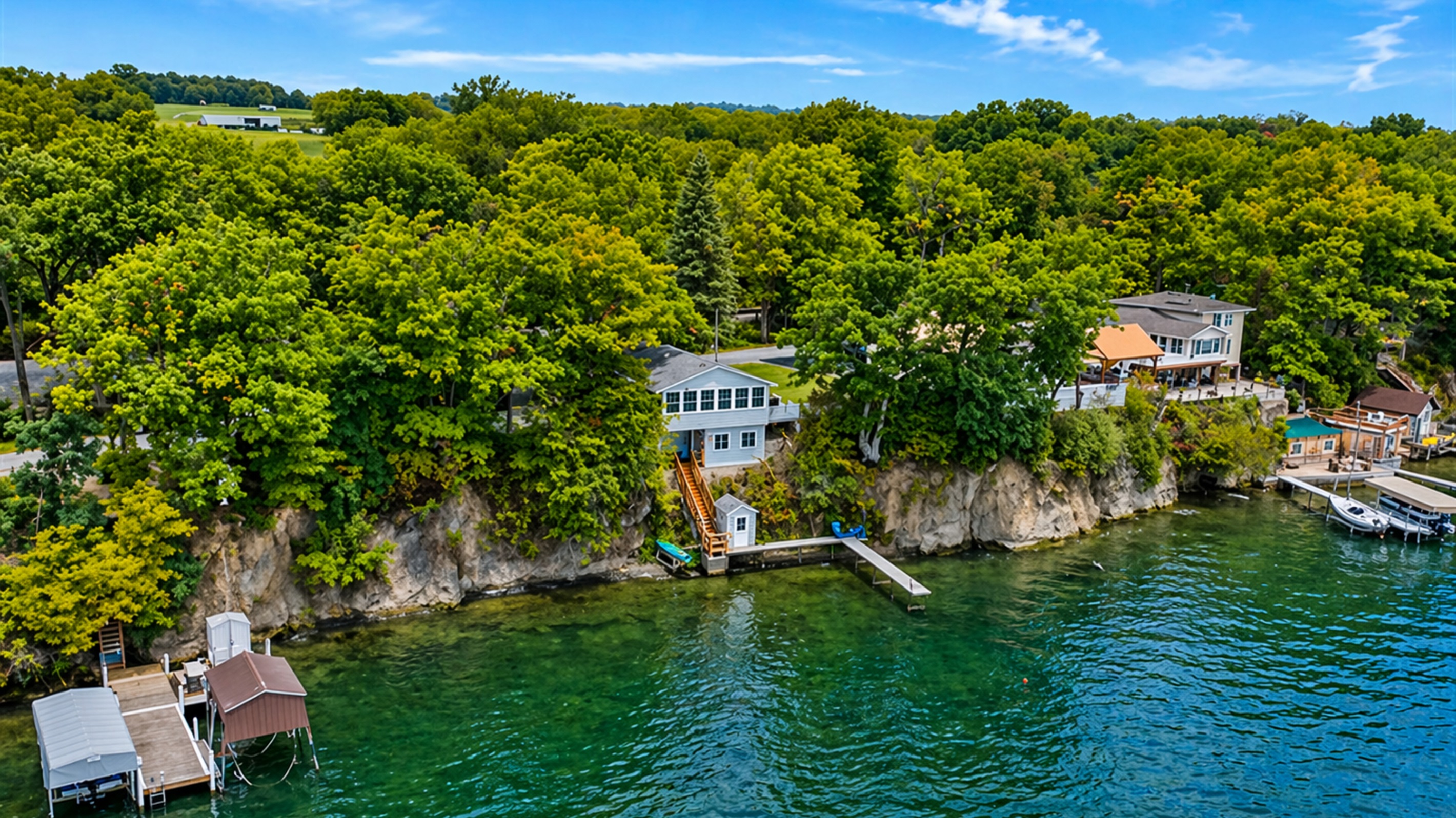 Soak in the breathtaking views of this cliffside cottage, perched right by the water with private dock access. Perfect for those seeking a secluded retreat surrounded by nature! 