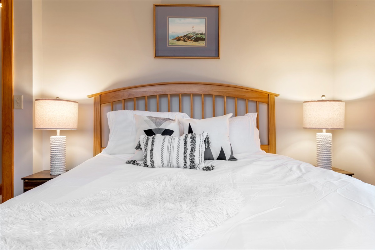 Recharge in a calm, sunlit bedroom where cozy linens and quiet surroundings make rest come easily after big days together.