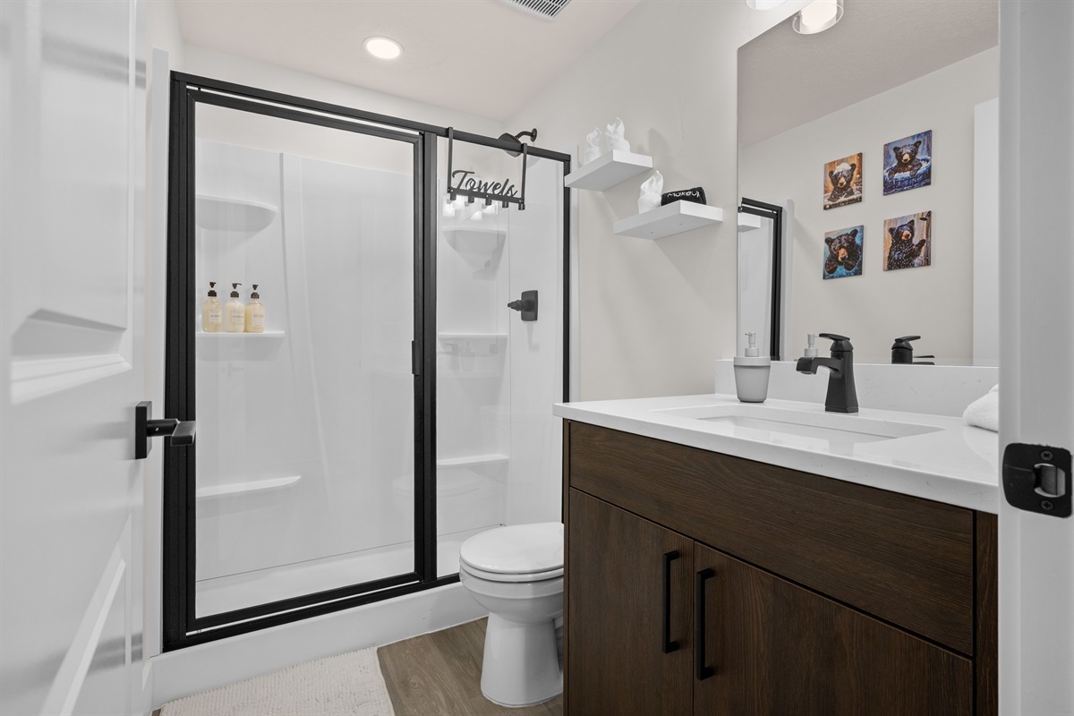 Stylish bathroom with glass-door shower and quartz vanity.