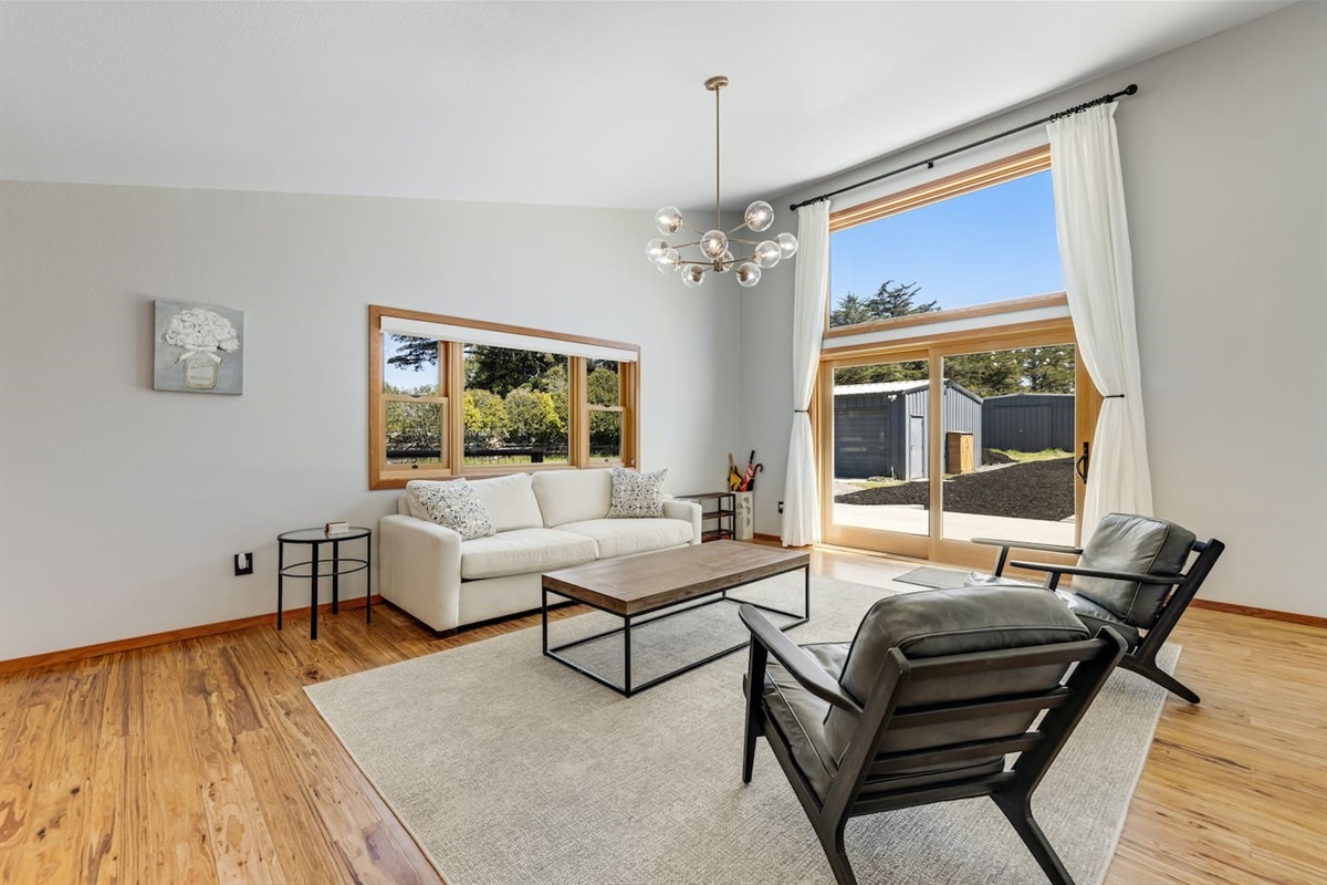 Relax in the bright living space with expansive windows.