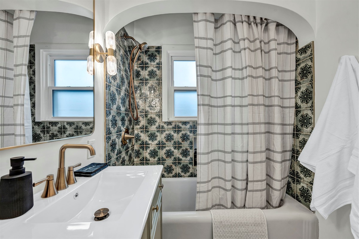 This bathroom offers a tub and shower.